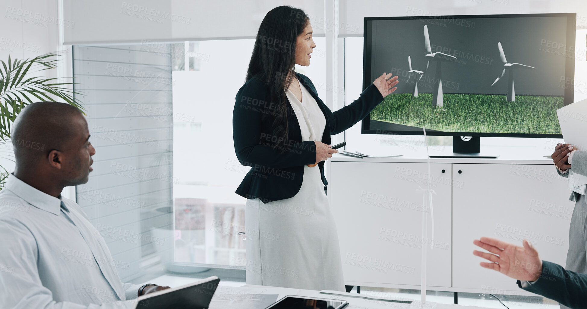 Buy stock photo Business woman, windmill presentation and screen in office for innovation, energy and sustainable future. Engineering consultant, leader and team for brainstorming, wind power and clean electricity