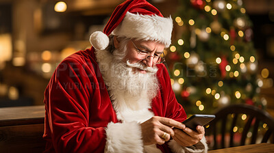 Portrait of santa sitting at desk typing on smartphone. Christmas concept.
