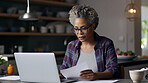 Laptop, documents and finance with a senior woman busy on a budget review or pension fund