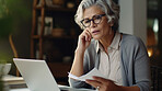 Laptop, documents and finance with a senior woman busy on a budget review or pension fund