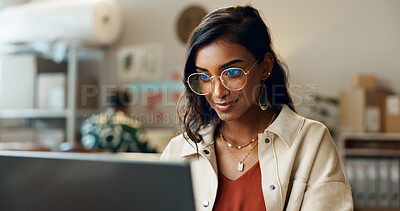 Buy stock photo Woman, business and reading on laptop at work for research, feedback and supply chain for business. Indian, person and planning on pc for logistics, stock administration or package distribution data