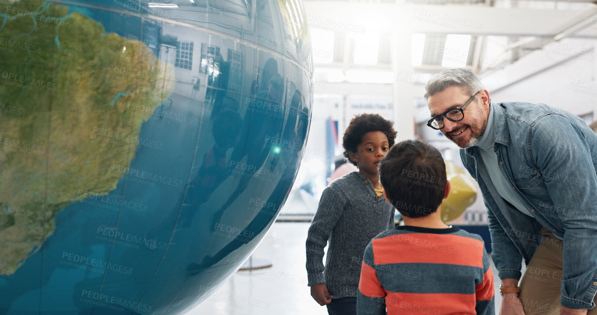 Buy stock photo Science, geography and students learning about the earth with a teacher at school for growth or development. World, globe or planet with a man teaching kids about climate change or global warming