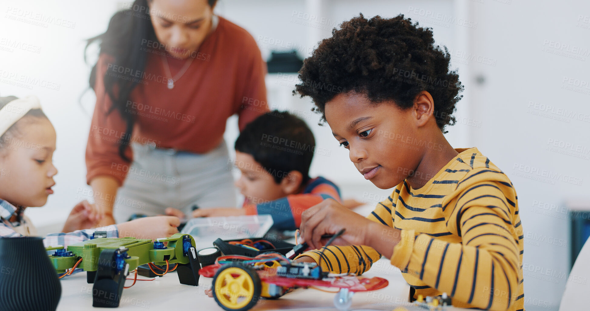 Buy stock photo Technology, boy and car robotics at school for learning, education or electronics with car toys for innovation. Classroom, learners and transportation knowledge in science class for research or study