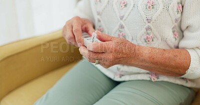 Sick, medicine and hands of person on the sofa for routine medical supplement in a house. Closeup, daily and a woman with pills, tablet or vitamin c for healthcare on the living room couch of a home