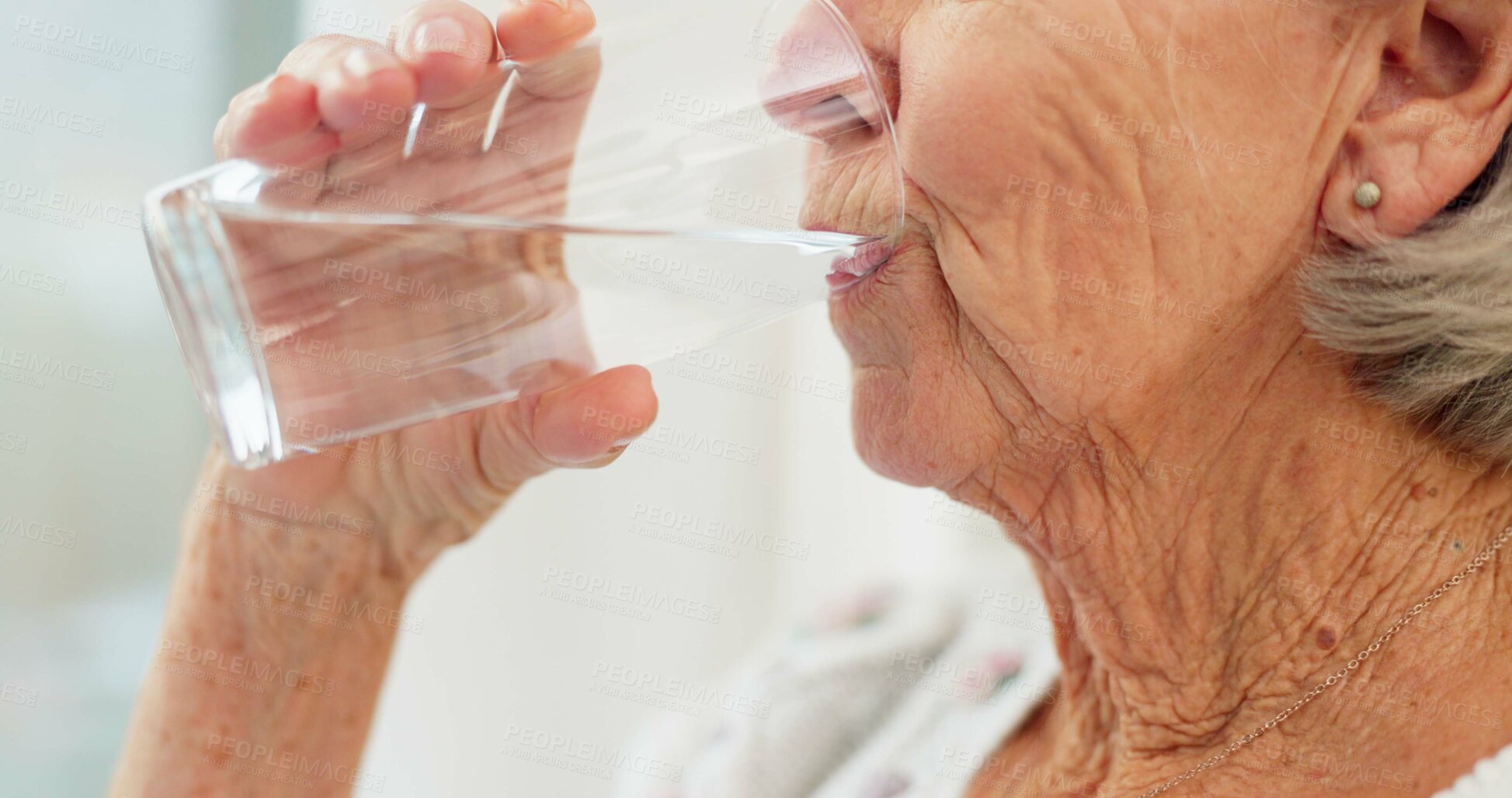 Buy stock photo Thirsty, closeup and senior woman drinking water for hydration and liquid diet detox at home. Wellness, health and calm elderly female person enjoying glass of cold drink in modern retirement house.