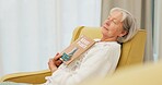 Relax, book and senior woman sleeping in the living room of her modern house on a weekend. Calm, peace and elderly female person in retirement taking a nap after reading a story or novel at home.