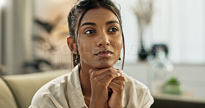 Thinking, brainstorming and young woman on a sofa relaxing with an idea or memory in living room. Reflection, doubt and nervous Indian female person with decision in the lounge of modern apartment.