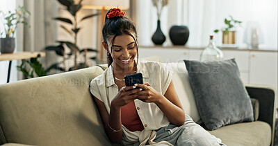 Buy stock photo Woman, smile and scroll on cellphone, social media post and update subscription app on sofa at home. Happy indian girl, smartphone and download mobile games, reading notification and chat to contact 