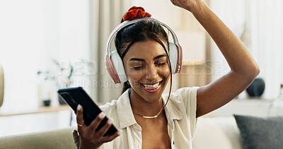 Smartphone, music and happy woman dance on sofa in home, celebration and listening to audio app. Phone, excited Indian person on headphones and radio, sound or freedom in living room on mobile tech