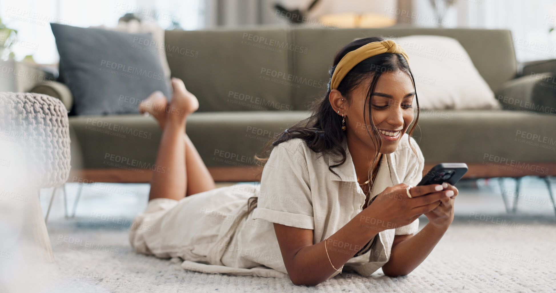 Buy stock photo Woman, phone and lying on floor with communication, typing or social media scroll in living room of home. Indian, girl and smartphone on ground for chat, texting or technology with internet in lounge