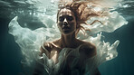 Model underwater wearing dress. Calm relaxation concept. Editorial concept.