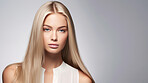 Portrait of young woman with long straight blonde hair. Hair care, make-up and hair health