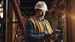 Civil engineer or professional building constructor holding a tablet and working on site