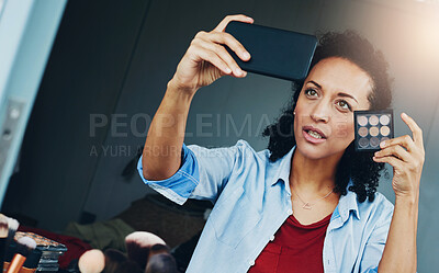 Buy stock photo Shot of a woman posing for a selfie with a makeup palette at home