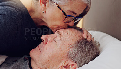 Senior woman kissing her husband on forehead with love, care and marriage in bed at home. Sick, recovery and elderly couple in retirement with illness in bedroom of hospice, nursing center or house.