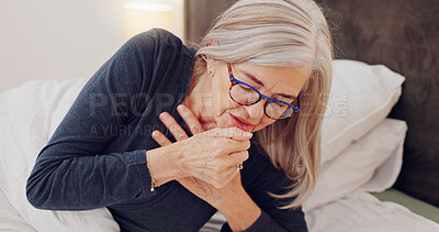 Sick, cough and senior woman in bed with allergies, flu or cold on a weekend morning at home. Illness, chest pain and elderly female person in retirement with asthma or infection in bedroom at house.