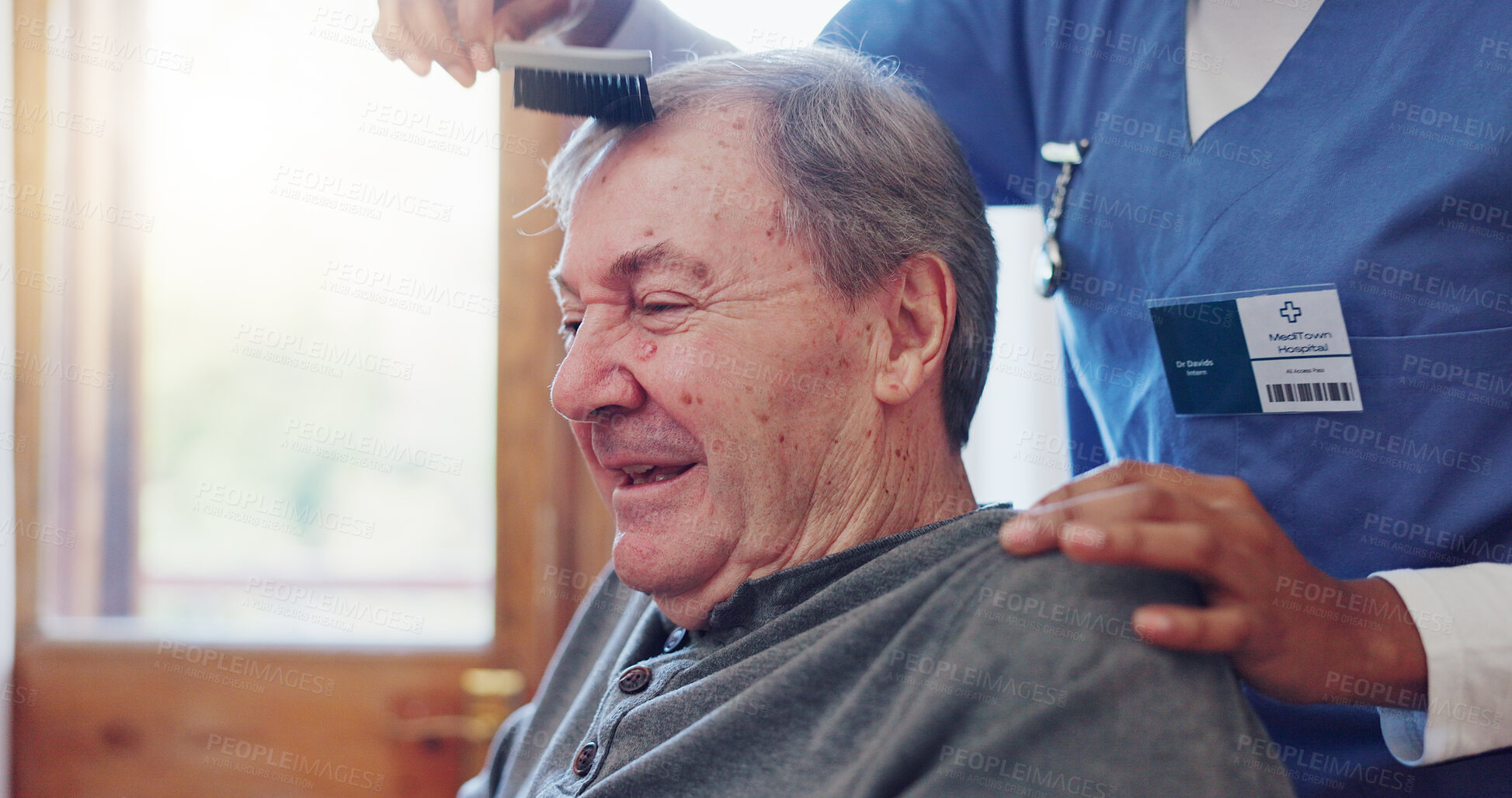 Buy stock photo Senior man, nurse and comb hair with smile for grooming, care and wellness with helping hand in retirement. Elderly person, caregiver and haircare in nursing home for support, assisted living or talk