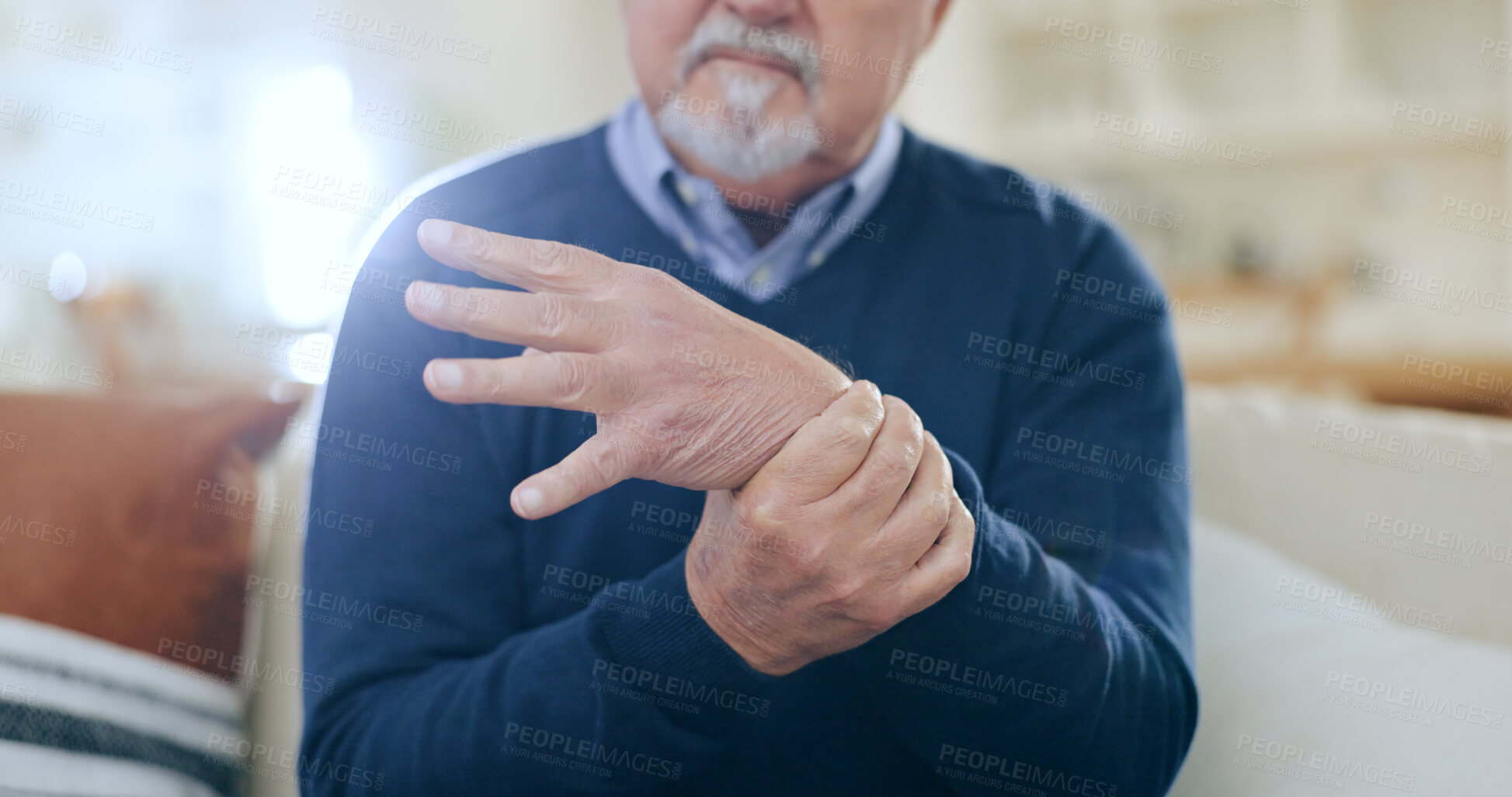 Buy stock photo Home, injury and senior man with wrist pain, bruise or inflammation with muscle tension in a lounge. Pensioner, old person and elderly guy on a sofa, accident or emergency with arthritis or broken