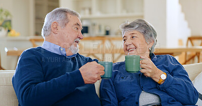 Tea, love and a senior couple in their home to relax together during retirement for happy bonding. Smile, romance or conversation with an elderly man and woman drinking coffee in their living room