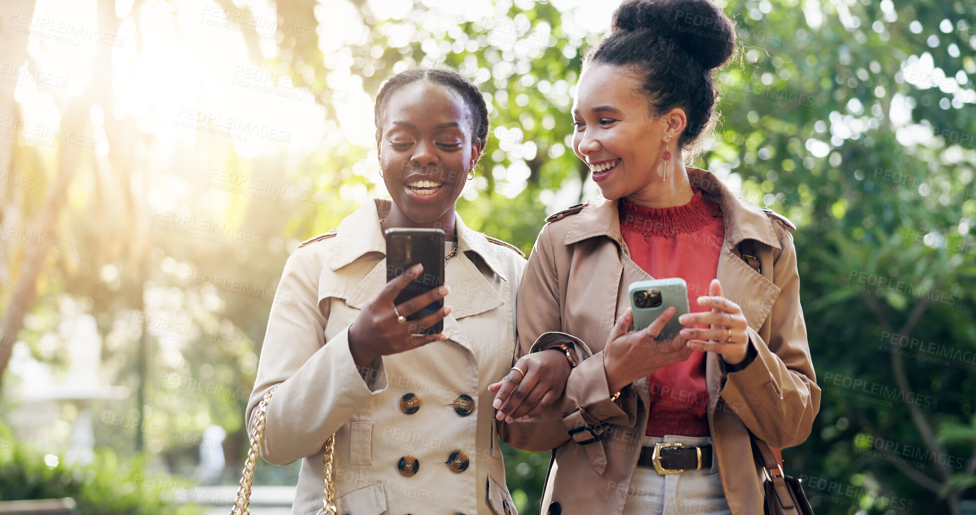 Buy stock photo Phone, social media and business woman friends walking in a park together during summer with flare. Smile, professional fashion and young employee people outdoor in a garden for mobile communication