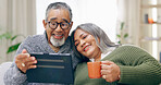 Tablet, home and senior couple with retirement, relax and coffee with happiness, social media and cheerful. Apartment, elderly woman and old man with tech, tea and relationship with marriage or app