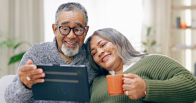 Buy stock photo Tablet, home and senior couple with retirement, relax and coffee with happiness, social media and cheerful. Apartment, elderly woman and old man with tech, tea and relationship with marriage or app