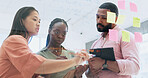 Business people, teamwork and writing in planning, meeting or schedule notes for strategy on glass board at office. Group of employees in team brainstorming, ideas or reminder for agenda at workplace