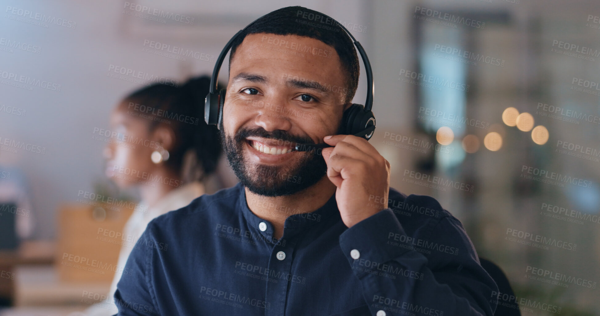 Buy stock photo Portrait, smile and man at call center on headphones for crm support on bokeh at night. Face, happy sales agent on mic and telemarketing consultant, customer service professional or worker in office