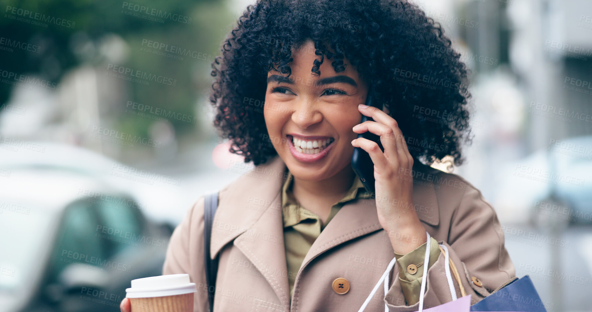 Buy stock photo Happy woman, smile and phone for communication on street while walking, coffee cup and shopping bags. African person, curly hair and excitement for conversation on commute to work in city for meeting