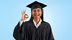 Graduate woman, ok sign and smile in studio with review with vote, choice and support by blue background. Graduation, girl and portrait with icon, emoji or decision with celebration, goals or success