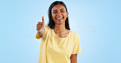 Buy stock photo Woman, smile in portrait and thumbs up for agreement, success or support with hand gesture on blue background. Like, yes and emoji with happiness, vote or opinion in studio with thank you or praise