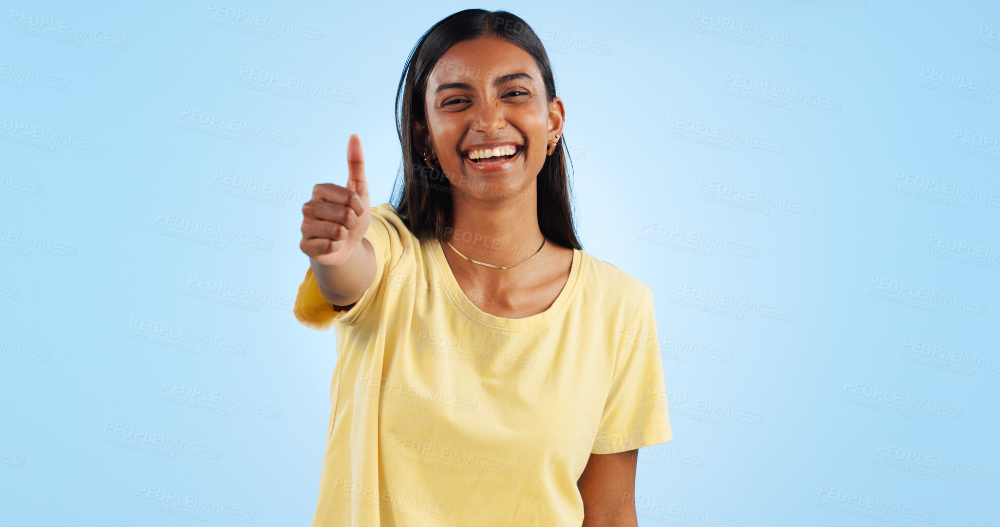 Buy stock photo Woman, smile in portrait and thumbs up for agreement, success or support with hand gesture on blue background. Like, yes and emoji with happiness, vote or opinion in studio with thank you or praise