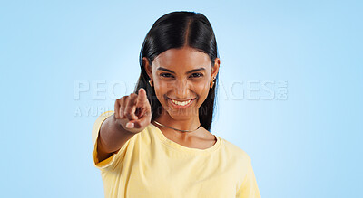 Portrait, pointing to you and woman with motivation, emoji and reaction with happiness on a blue background. Face, happy person and model with hand gesture, mockup space and winning with support