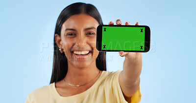 Cellphone green screen, studio portrait and happy woman show web announcement, mobile info or app chroma key UI. Tracking markers, smartphone mockup space and Indian person face on blue background