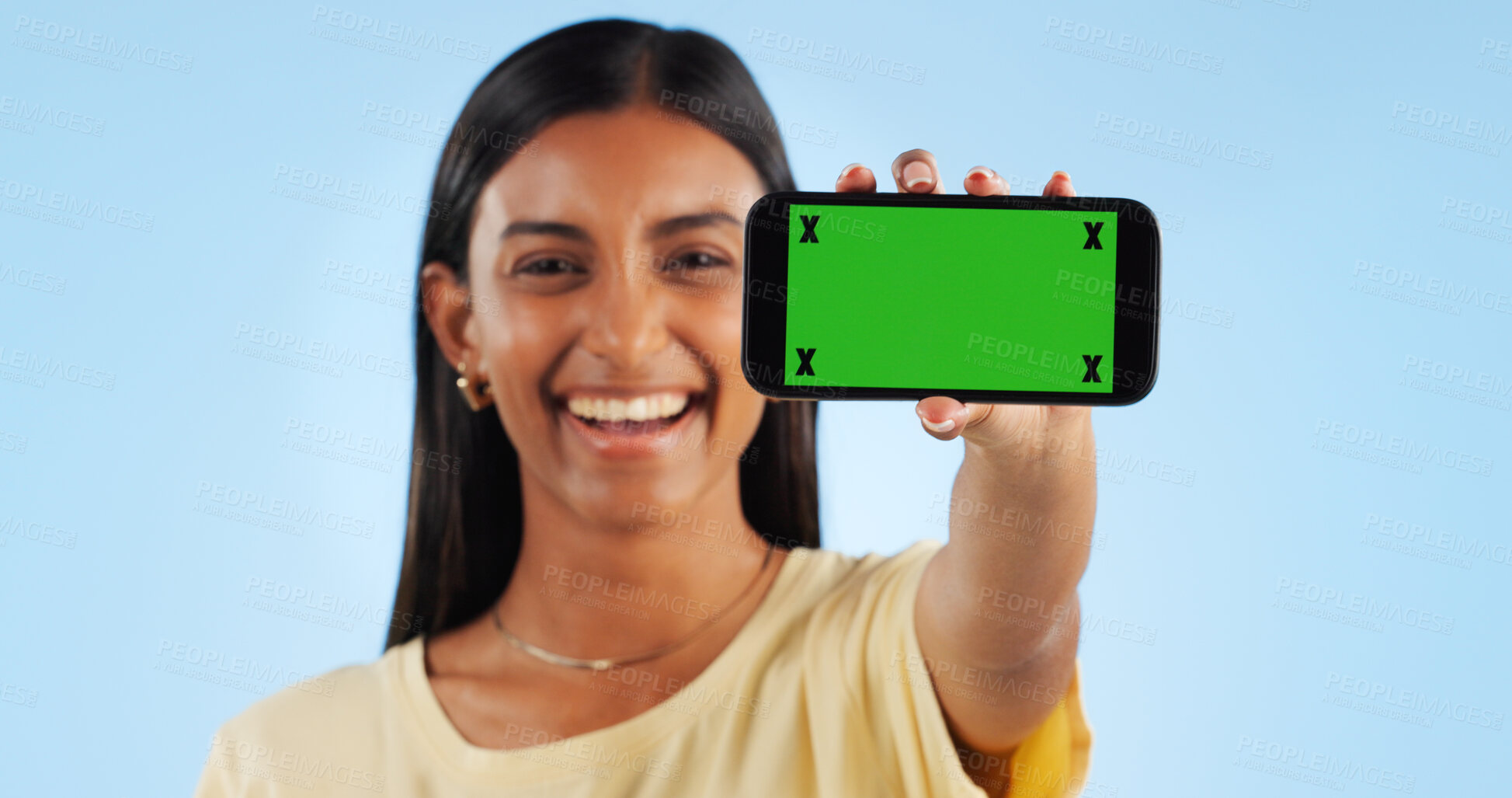 Buy stock photo Cellphone green screen, studio portrait and happy woman show web announcement, mobile info or app chroma key UI. Tracking markers, smartphone mockup space and Indian person face on blue background