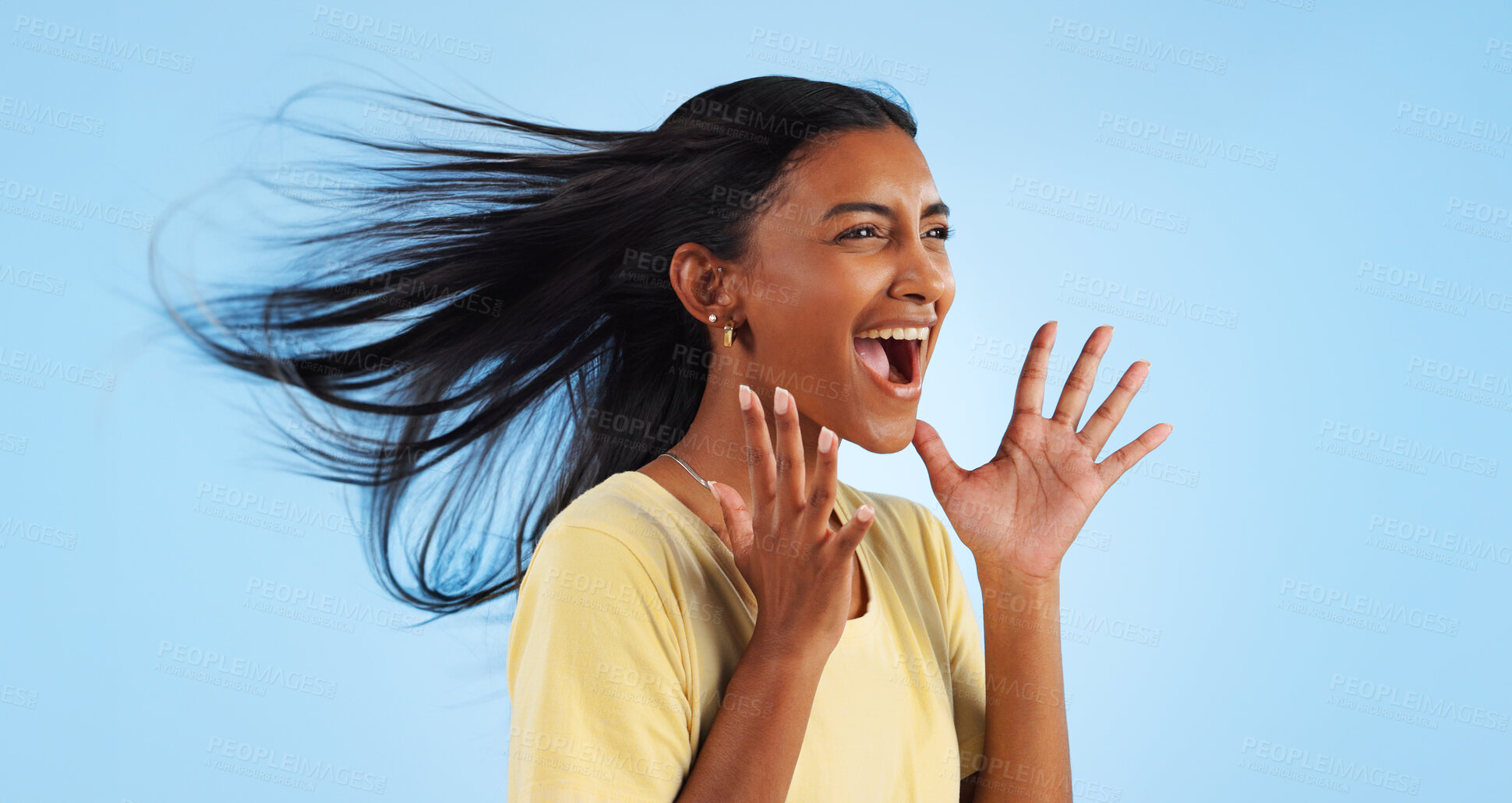 Buy stock photo Woman, scream and wind for hair in studio for mock up on blue background with good news. Indian person, happy and smile in excitement for winning with success, celebration or announcement in space