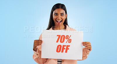 Woman, promotion poster and portrait with sale, discount and billboard in studio. Excited, smile and happy from savings and deal paper with banner and promo with blue background and price decrease