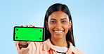 Smartphone green screen, studio portrait and happy woman show internet connection, mobile promotion or app chroma key. Tracking markers, cellphone mockup space and tech person face on blue background