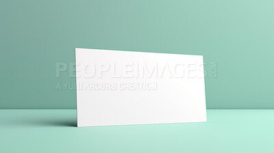 Blank white business card or gift voucher card on a turquoise background. Birthday gift