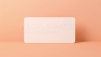 Blank white business card or gift voucher card on a salmon background. Birthday gift