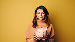 Young woman holding a piggy bank. Savings, budget and money management concept