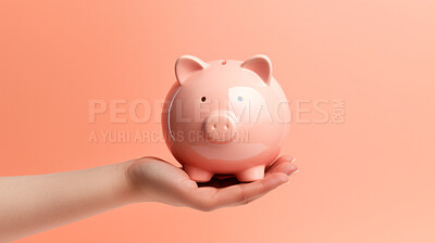 Hand holding a piggy bank. Savings, budget and money management concept
