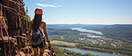 Candid shot of hiker on mountain top looking at view. Extreme sport concept.