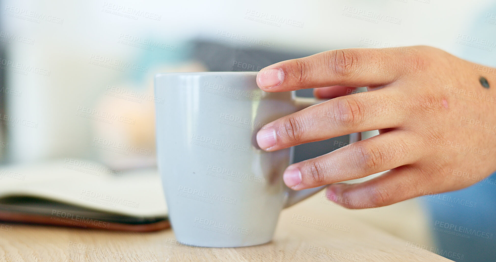 Buy stock photo Closeup, hand and a person with coffee and a notebook in the morning for reflection, relax or reading. House, table and a person with a latte, tea or a warm drink in the morning with a journal