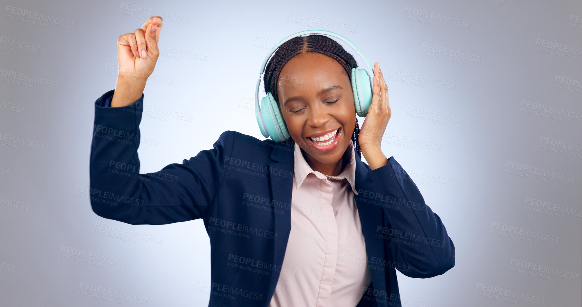 Buy stock photo Dance, headphones and business woman in studio for celebration, freedom and excited for winning on grey background. Happy african worker listening to music, audio or streaming radio sound with energy