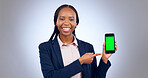 Business woman, smartphone and pointing to green screen for advertising space, offer and mockup newsletter in studio. Portrait, happy african worker and mobile announcement of deal on grey background