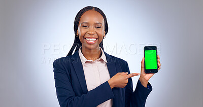 Buy stock photo Business woman, smartphone and pointing to green screen for advertising space, offer and mockup newsletter in studio. Portrait, happy african worker and mobile announcement of deal on grey background