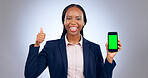 Green screen, phone and thumbs up by business woman in studio with mockup on grey background. Smartphone, app and portrait of African female entrepreneur with emoji, vote or support for app platform