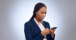 Thinking, phone and annoyed black woman confused by text in studio for fake news, review or feedback on grey background. Doubt, face and African small business owner with smartphone scam notification