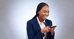 Business woman, phone and typing in studio for networking, funny mobile chat or social media post. Happy african worker laugh with cellphone, reading news app or online information on grey background